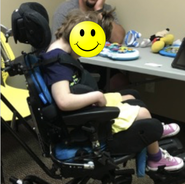 Girl with a forward head and rounded shoulders in a wheelchair